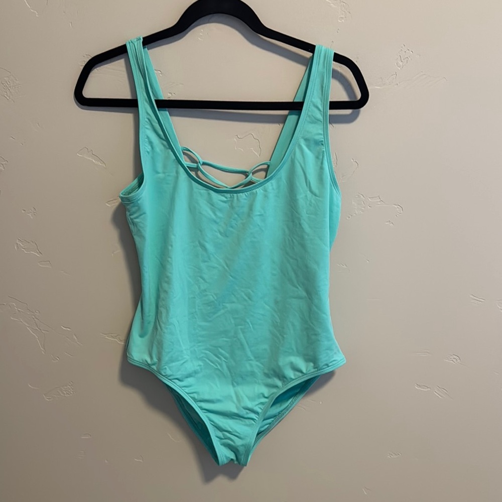 LSpace Tiffany blue one piece with decorative back. Women’s size 12.  NWOT